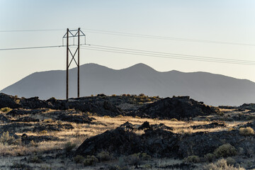 The silhouette in the distance is Big Southern Butte. Basalt (Quaternary) Lava Flows. Volcanic Field. U.S. Highway 26 (US 26) ,Idaho. Snake River Plain. 