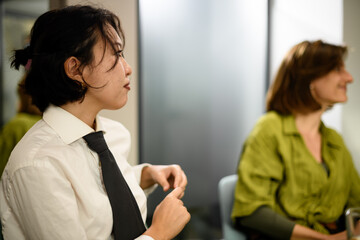 Business meeting with diverse professionals discussing ideas in a modern office environment in the afternoon