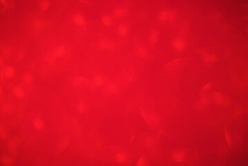 Defocused red glitter background. Abstract red defocus light.