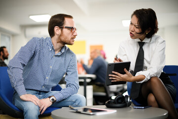 Business meeting between professionals discussing strategy and ideas in a modern office setting