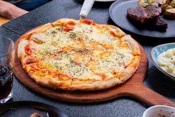 mozzarella pizza served on wooden restaurant table