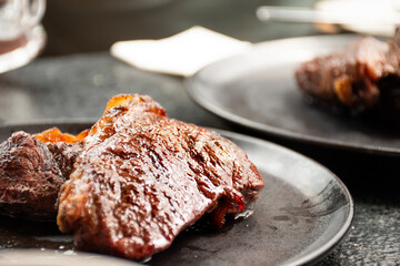 two slices of juicy fat picanha steak cut of beef in steakhouse
