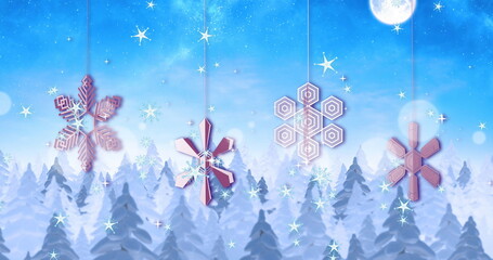 Fototapeta premium Image of stars falling and snowflakes over winter scenery