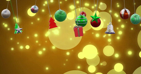 Image of christmas baubles decoration and glowing spots on brown background