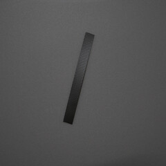 Close-up of a yellow plastic strap tied in a simple knot against a light surface. The image highlights its smooth texture, flexibility, and industrial design.