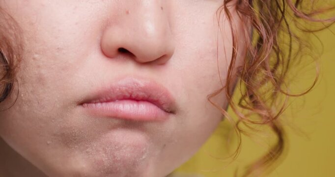 Close-up portrait of a young woman puckering lips in a playful expression