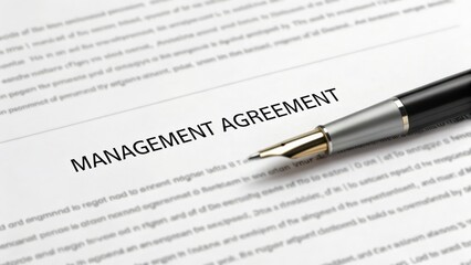 agreement owner management interest concept. Management agreement document with a pen on top.