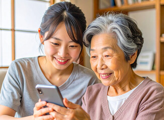 おばあちゃんにスマホの使い方を教える孫娘