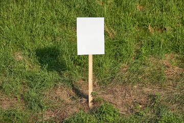 Empty sign on a land, green grass