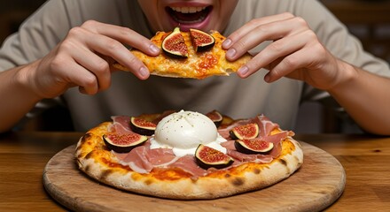 Close-up of person enjoying pizza with figs, prosciutto and burrata cheese on wooden board