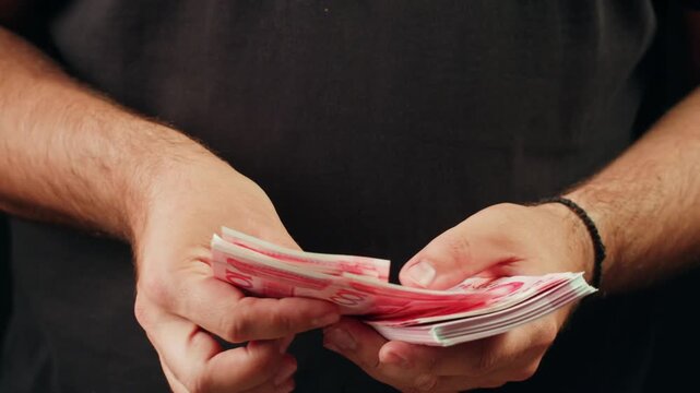 Person holding Chinese Yuan banknotes 4k video