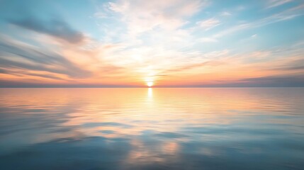 Obraz premium Stunning Sunset Over Calm Ocean Waters with Beautiful Cloud Reflections in Smooth Ripples