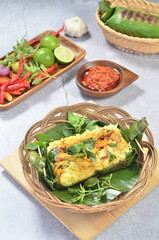 Grilled rice with stir fry chicken, wrapped in banana leaves, traditional Indonesian food