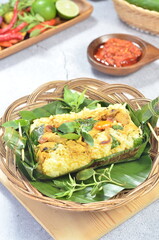 Grilled rice with stir fry chicken, wrapped in banana leaves, traditional Indonesian food