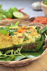 Grilled rice with stir fry chicken, wrapped in banana leaves, traditional Indonesian food