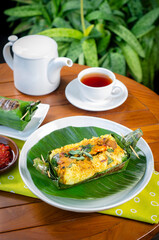Grilled rice with stir fry chicken, wrapped in banana leaves, traditional Indonesian food