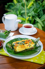 Grilled rice with stir fry chicken, wrapped in banana leaves, traditional Indonesian food
