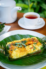 Grilled rice with stir fry chicken, wrapped in banana leaves, traditional Indonesian food