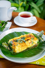 Grilled rice with stir fry chicken, wrapped in banana leaves, traditional Indonesian food