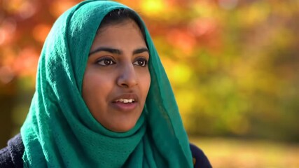 Portrait of a Smiling Woman in a Teal Hijab