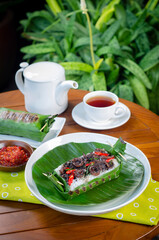 Grilled rice with stir-fried squid, wrapped in banana leaves, a traditional Indonesian dish