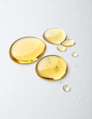 Golden Liquid Droplets on a White Background, Close-Up of Facial Oil or Serum on Plain Backdrop