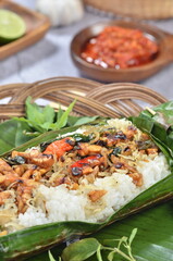 Grilled rice with anchovies and tempeh, wrapped in banana leaves, a traditional Indonesian dish