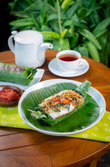 Grilled rice with anchovies and tempeh, wrapped in banana leaves, a traditional Indonesian dish