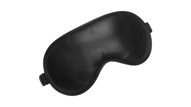 Close up of a black leather golf club headcover isolated on a solid black background studio shot