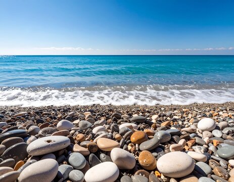 Pebble beach with blue ocean and clear sky