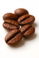 Naklejka premium Macro Shot of Roasted Coffee Beans on Clean White Background