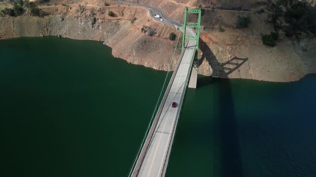 Aerial of car driving over Bidwell Bar Bridge over Lake Oroville in north California