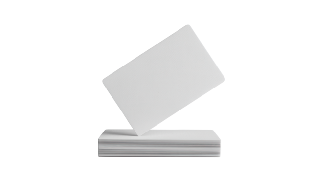 A single blank white card stands upright on a stack of identical white cards against a stark black background