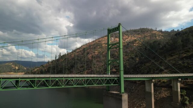 Aerial over Bidwell Bar Bridge over lake Oroville in California tilt down
