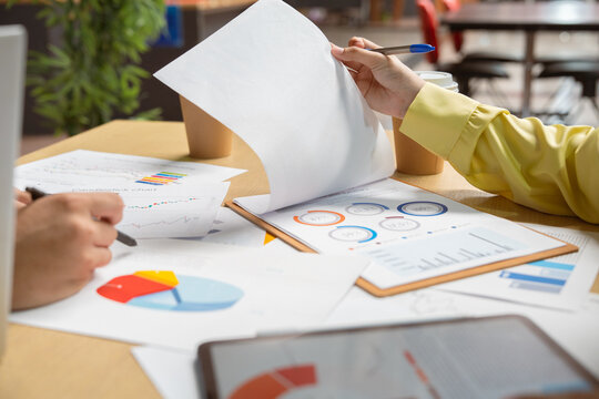 Business people, hands-on work, and people with documents in the office for data analysis. Financial analysts, teams, and documents for financial forecasting, budget planning, or strategy.