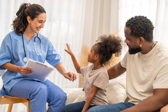 Doctor use tablet for medical checkup consulting african child about health while father sits beside, concept of pediatric healthcare, digital diagnosis, telemedicine, patient care and family support