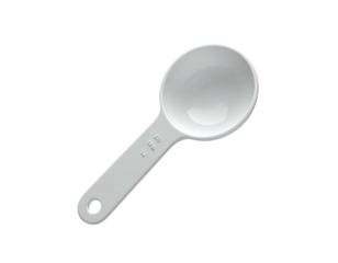 A white plastic measuring spoon isolated on black, angled, with measurements