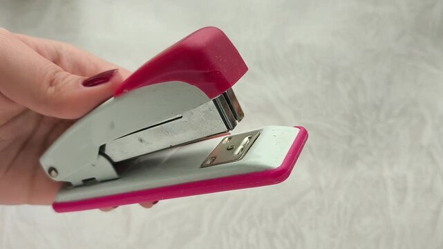Paper staple in a woman's hand