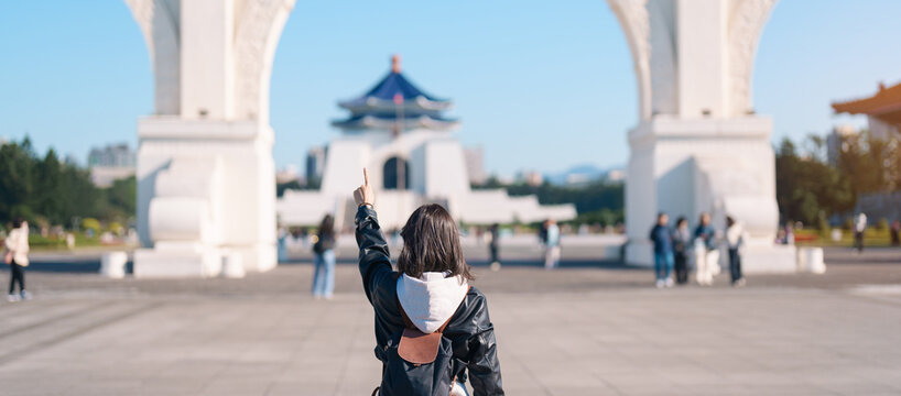 woman traveler visiting in Taiwan, female Tourist sightseeing at National Chiang Kai shek Memorial or Hall Freedom Square, Taipei City. Popular landmark and attractions. Asia Travel concept