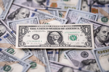 Money background with dollar bills. Texture of US dollars. 100 USD banknotes in focus. American hundred-dollars notes spread on a table. Pattern of US dollars for finance concept. Dollars currency.