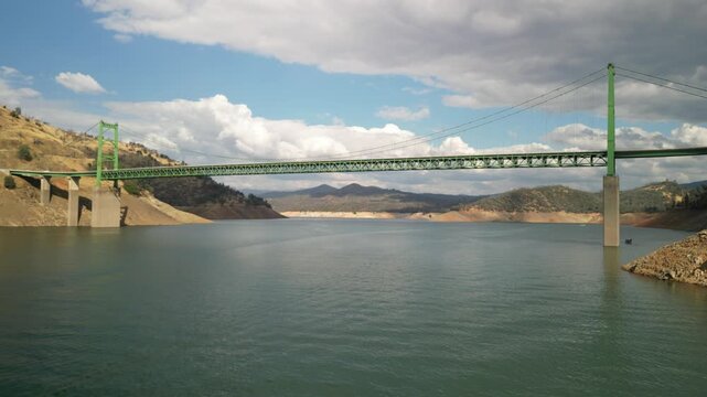 Low aerial over Lake Oroville under Bidwell Bar Bridge in Northern California