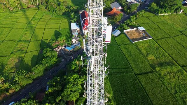 Rare Stunning Drone Aerial Climb Telecommunication Tower Wireless Internet WiFi 5G Above Countryside Landscape in Green Rice Fields during day in 4K