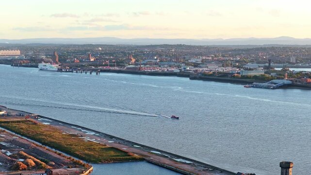 Cinematic aerial drone footage of the surrounding river near Everton FC&rsquo;s new Bramley-Moore Dock stadium in Liverpool, England. Captured at sunset showing the water front.