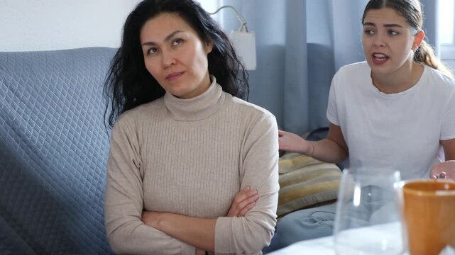 Annoyed stressed woman ignoring girlfriend after quarreling at home, LGBTQ relationship problems concept