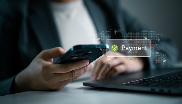 Businesswoman holding smartphone and laptop with digital payment and global map icons. Secure mobile payment, online banking, digital finance and international e-commerce transactions.