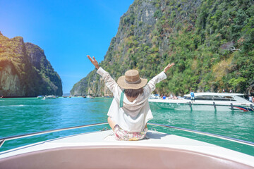 Woman tourist on boat trip, happy traveller relaxing at Pileh lagoon on Phi Phi island, Krabi,...