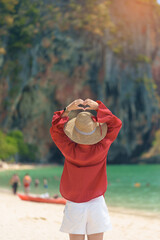 Woman tourist travel and sightseeing in Krabi, Thailand. happy traveller enjoy on beach at Phra nang Cave Beach near Railay Beach. summer trip, destination, Southeast Asia Travel and vacation concept