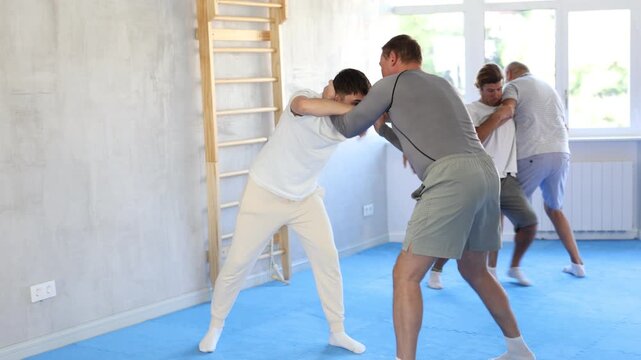 Judo lessons - young guy makes a power throw during judo or sambo classes