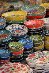 Naklejka premium Colorful handmade ceramic dishes at a market stall