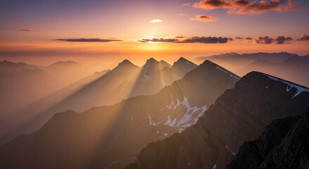 Golden hour paints the majestic mountain peaks with ethereal light, creating a breathtaking scene of natures beauty and serene tranquility at sunset
